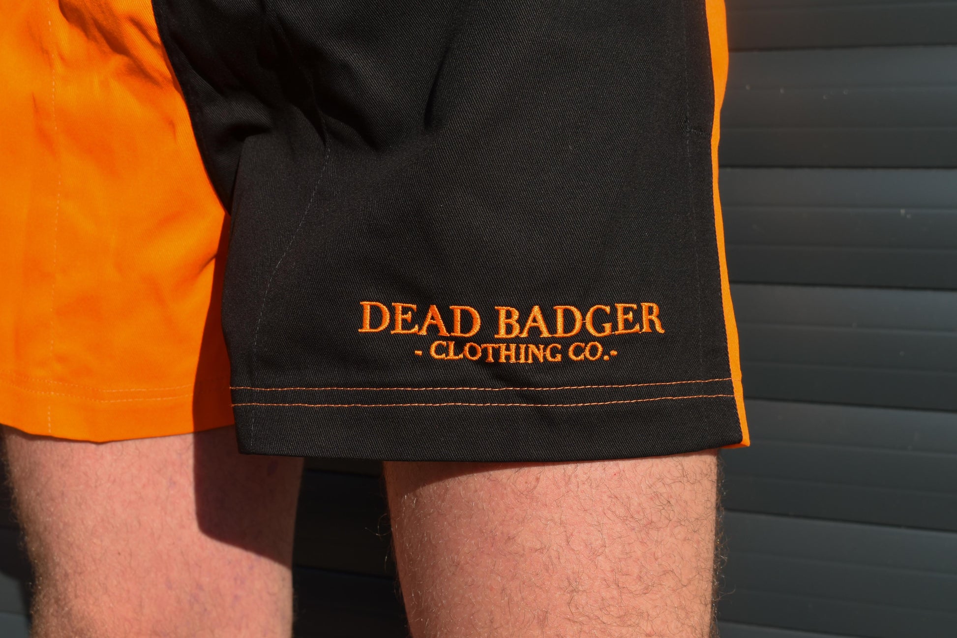 Dead Badger Clothing black and orange shorts detail
